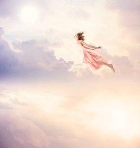 Girl in a pink dress flying in the sky